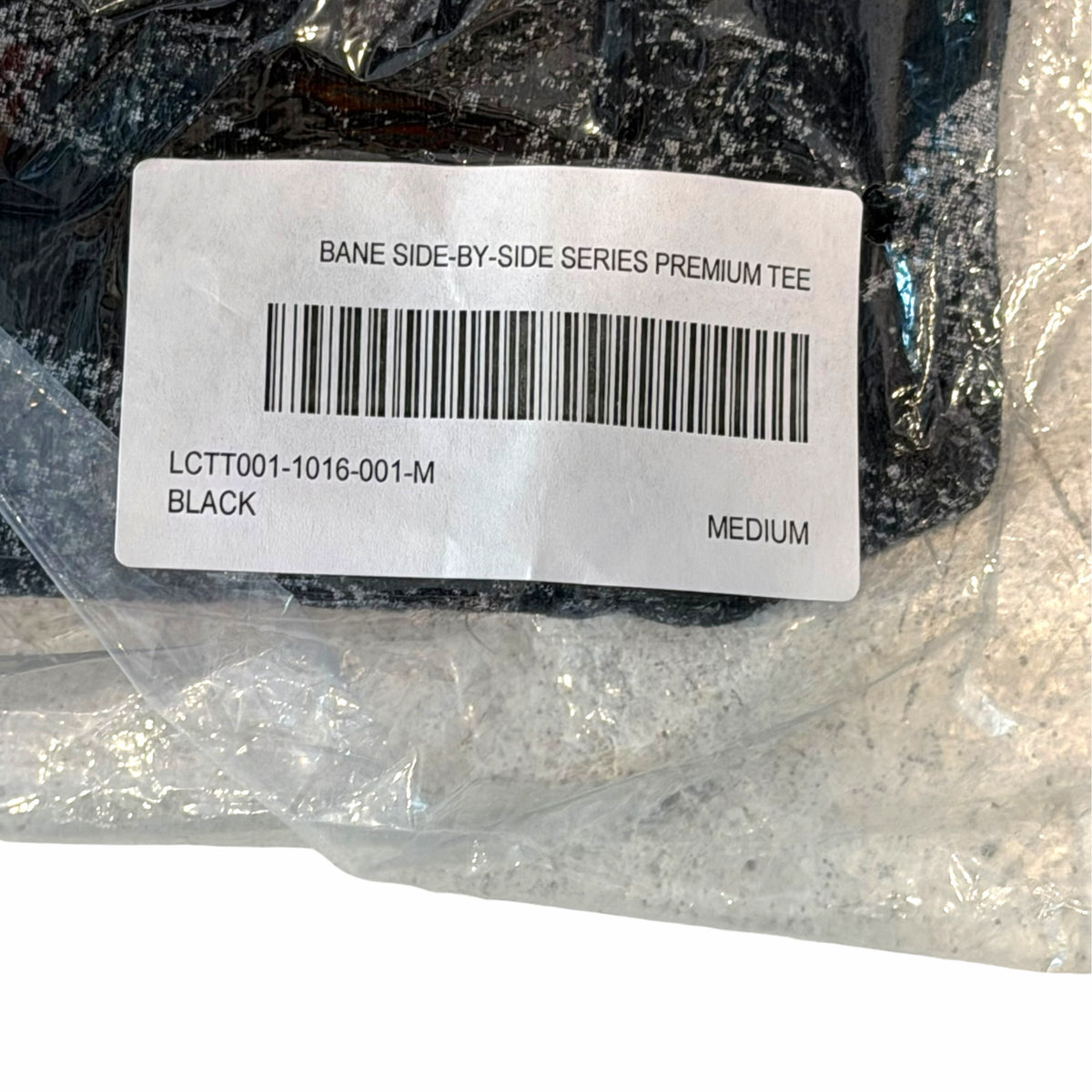 Vangsworld, Inc. Bane Side-By-Side Series premium black graphic t-shirt in original plastic packaging with barcode label