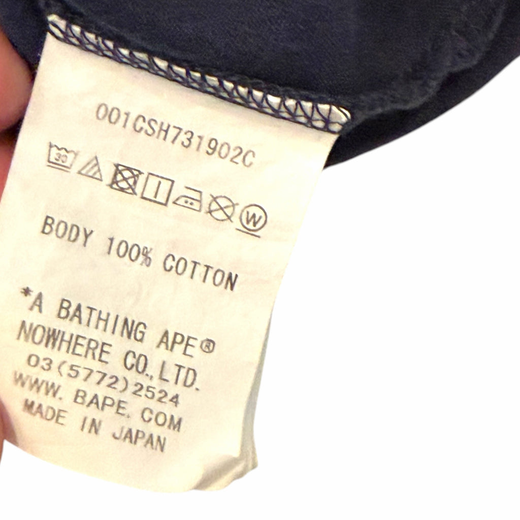 Vangsworld, Inc A Bathing Ape x Coach t-shirt interior care label showing 100% cotton material and made in Japan