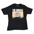 Vangsworld, Inc black cotton crewneck t-shirt featuring The Surface graphic print with peach background and band logo.