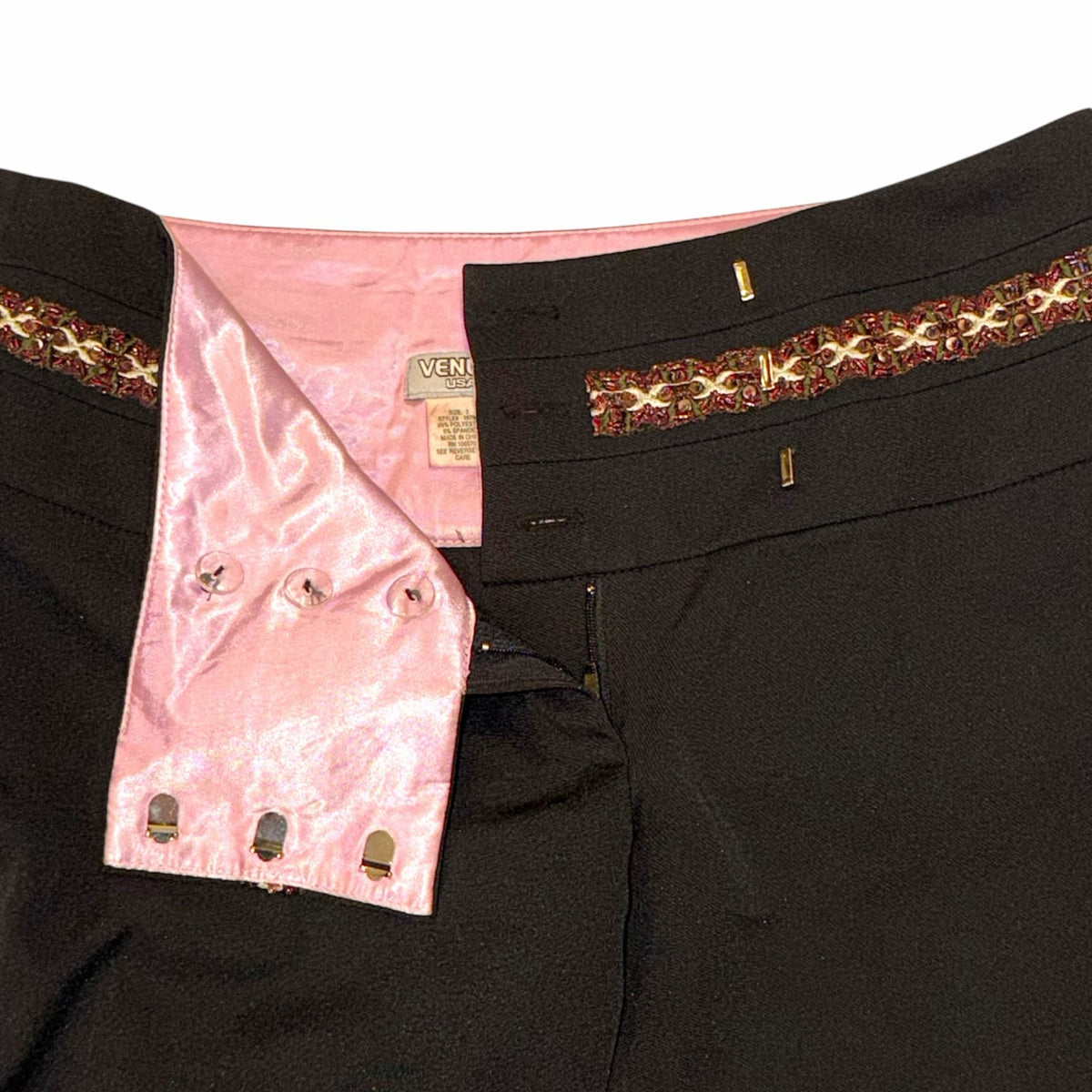 Vangsworld, Inc black dress pants featuring an intricate beaded waistband and a soft pink satin interior lining.