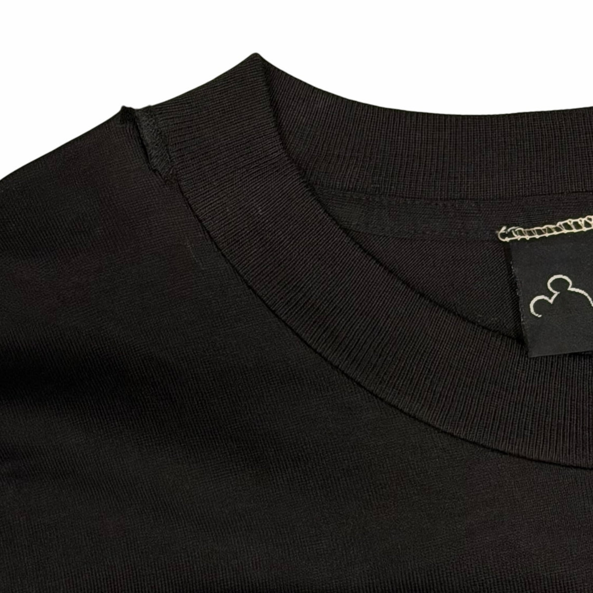 Vangsworld, Inc black cotton crewneck t-shirt with ribbed collar and Disney Originals tag detail