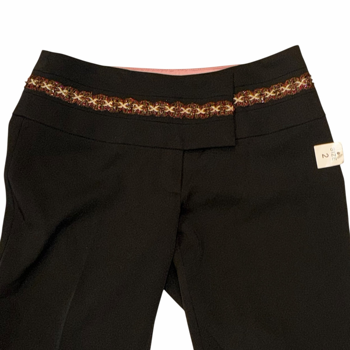 Vangsworld, Inc black dress pants featuring a decorative multi-colored beaded waistband and soft pink interior lining.