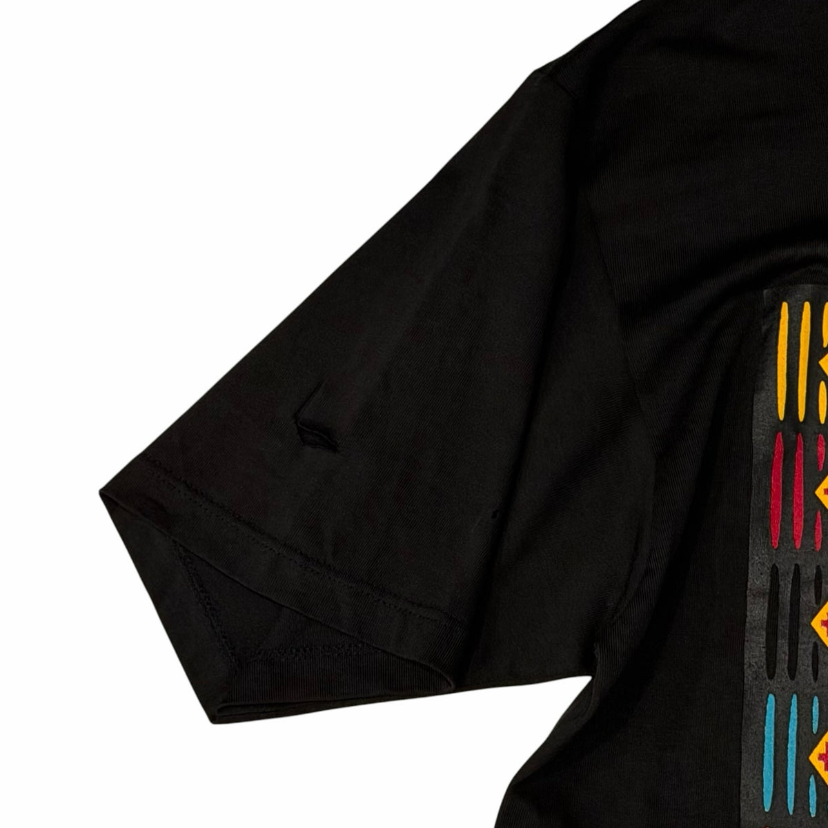Vangsworld, Inc black cotton crewneck t-shirt sleeve detail featuring a vibrant Lion King graphic print