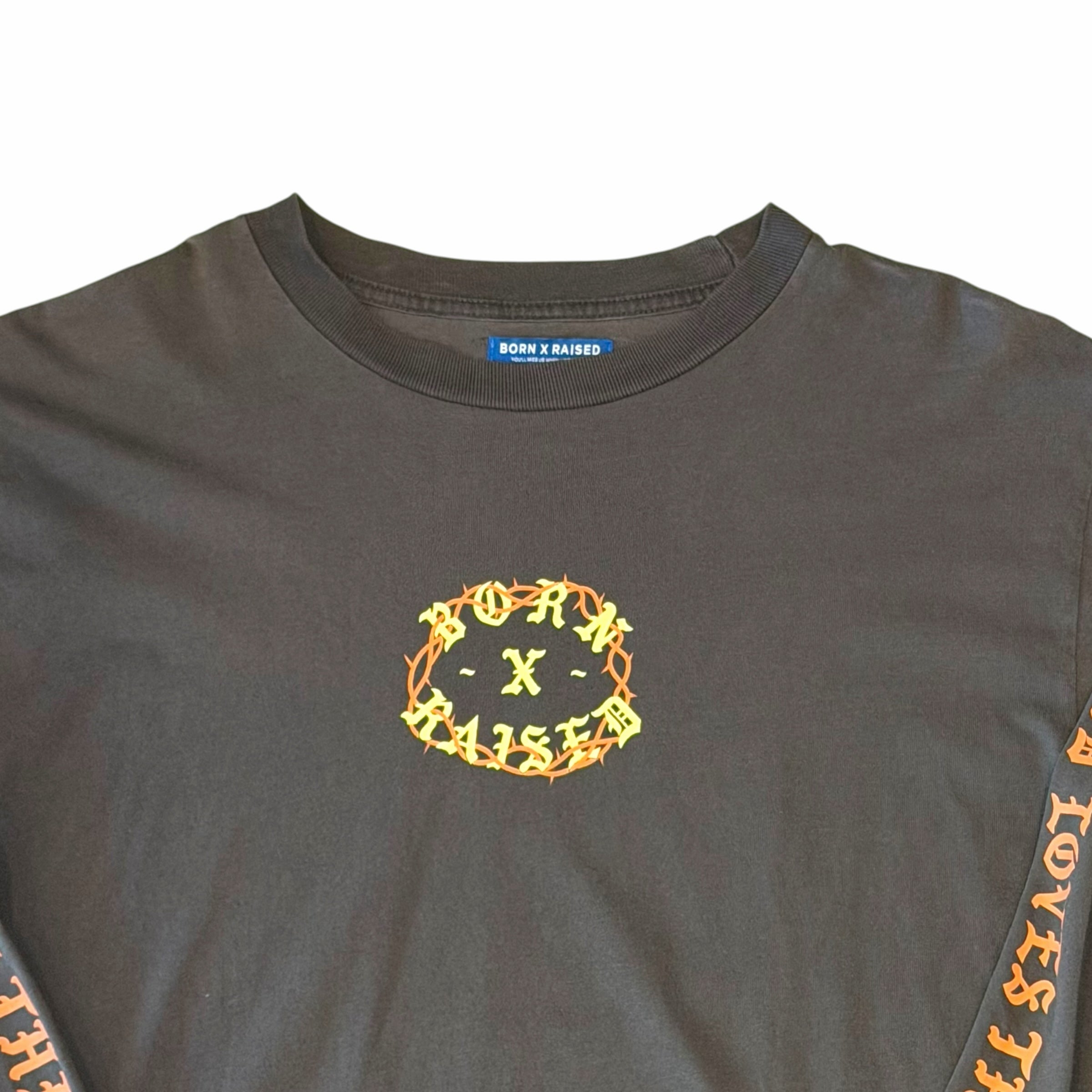 Vangsworld, Inc black long sleeve crewneck shirt with yellow thorn-encircled Born X Raised logo on the chest
