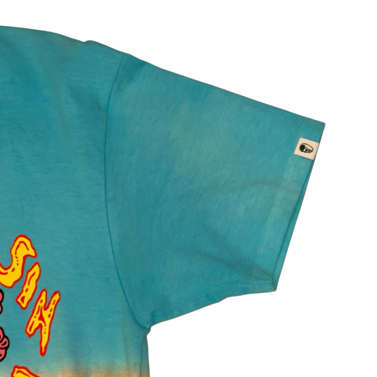 Vangsworld, Inc sky blue cotton t-shirt sleeve with branded tab and partial graphic print