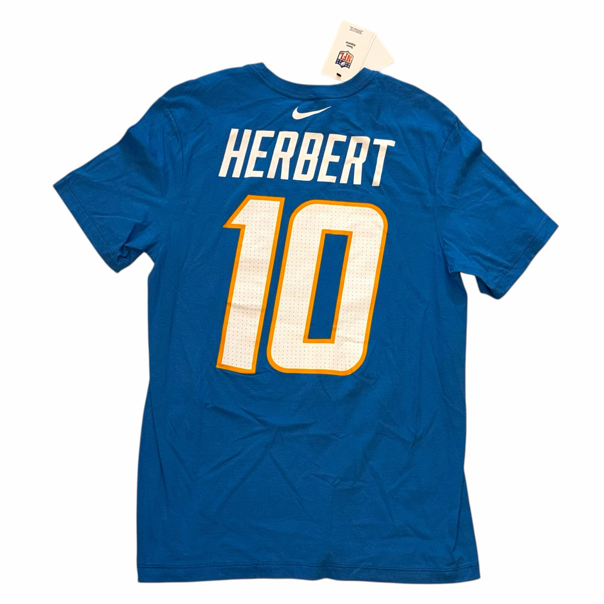 Vangsworld, Inc Los Angeles Chargers Justin Herbert number 10 blue Nike player t-shirt, back view with NFL tag.