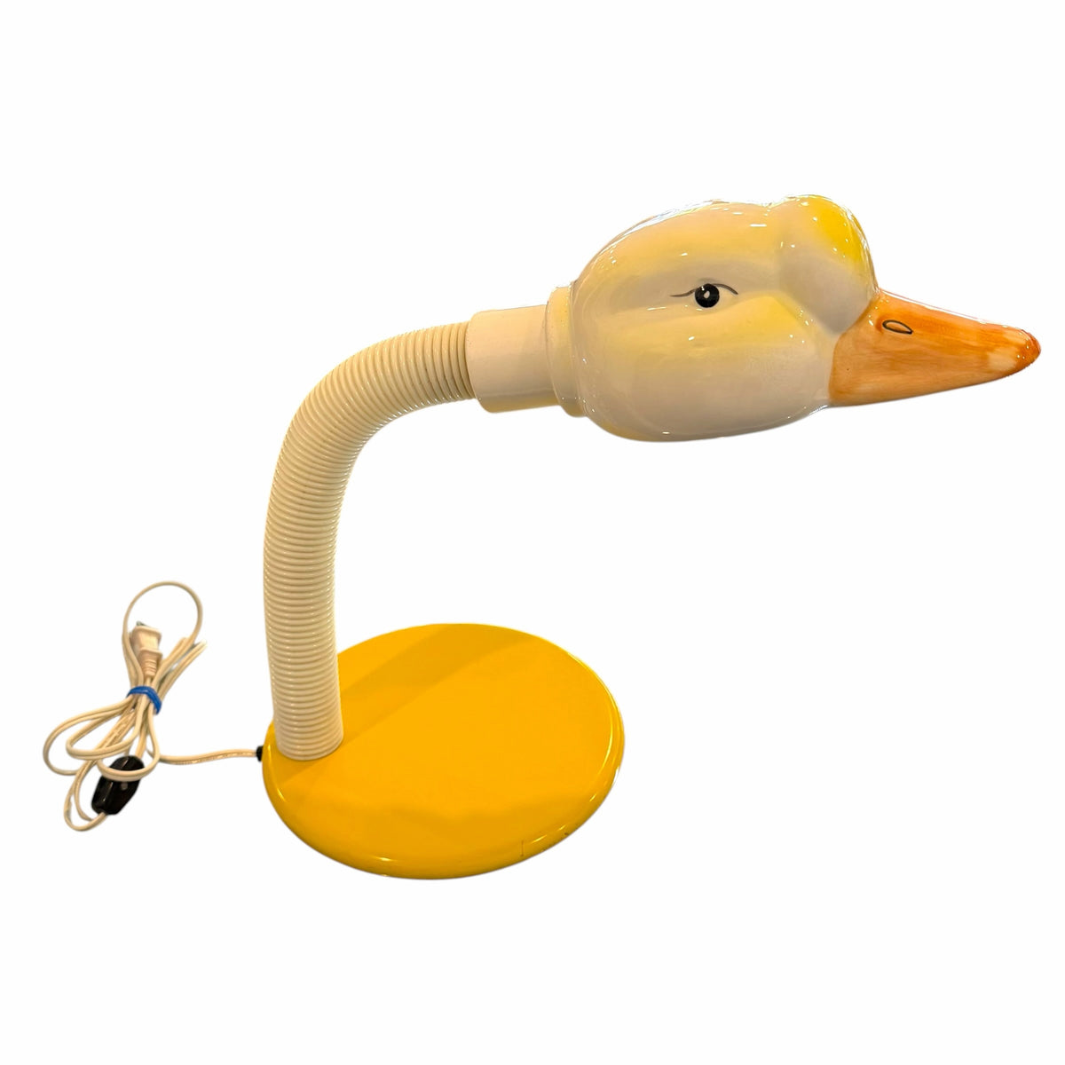 Vangsworld, Inc whimsical duck-shaped ceramic desk lamp with a flexible neck and vibrant yellow circular base.