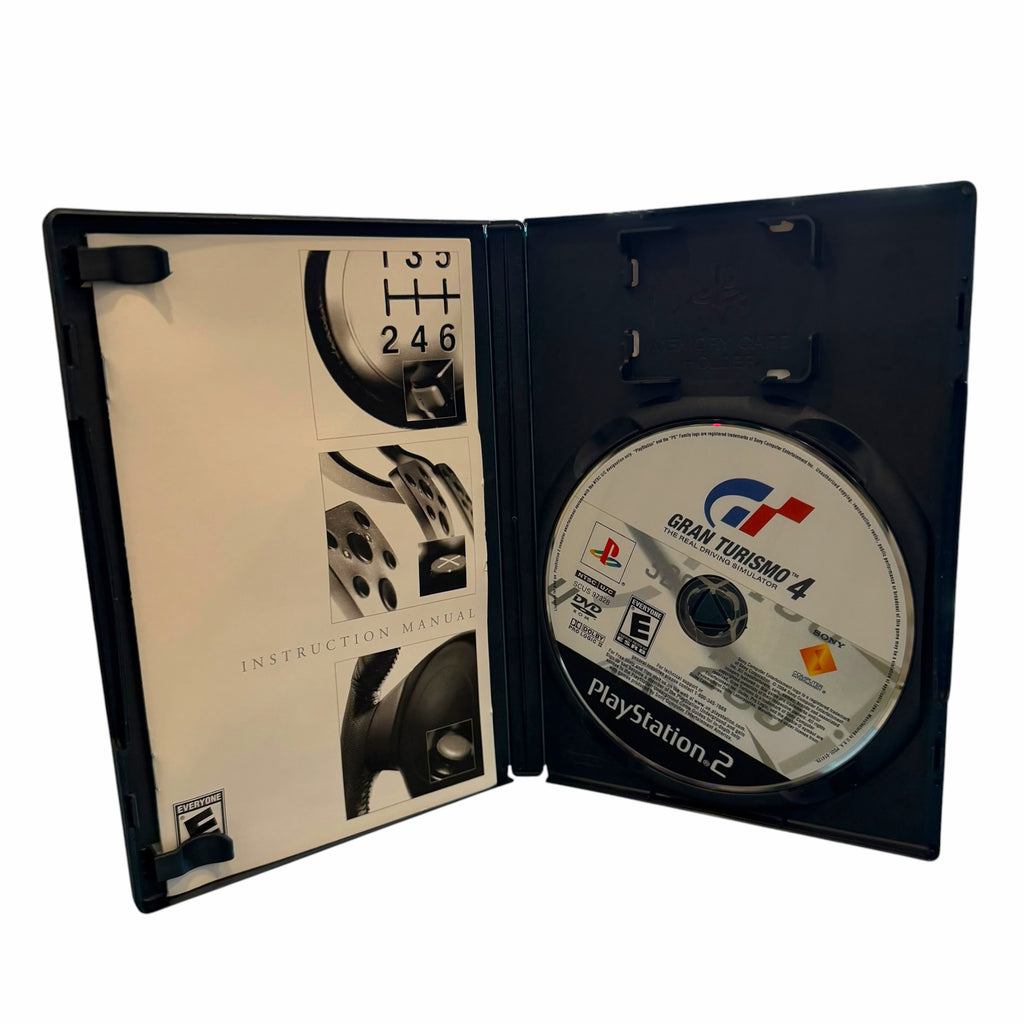 Vangsworld, Inc Gran Turismo 4 PS2 game disc and instruction manual inside an open black plastic protective case