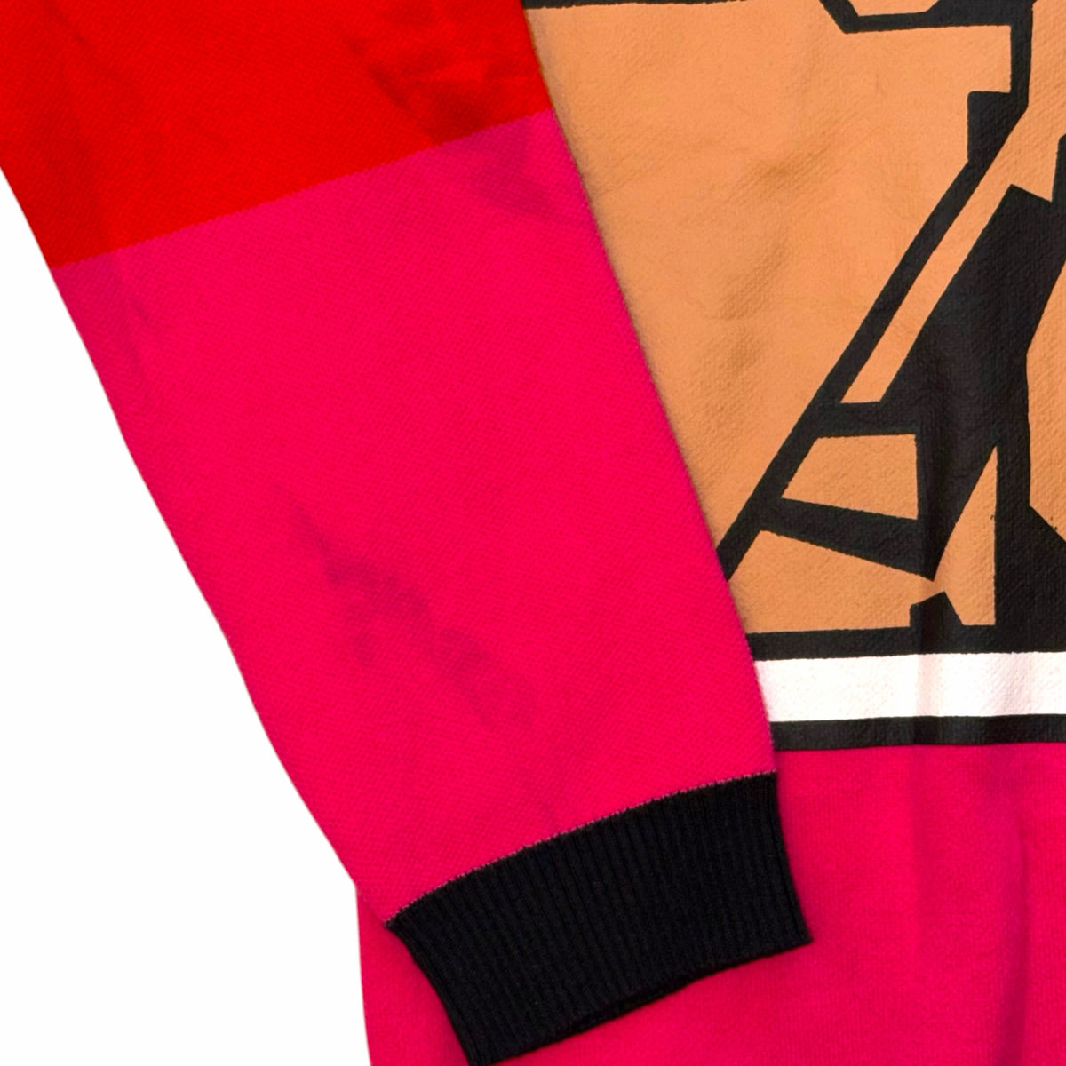 Vangsworld, Inc graphic crewneck sweater featuring abstract red, pink, and black knit patterns with ribbed cuffs.