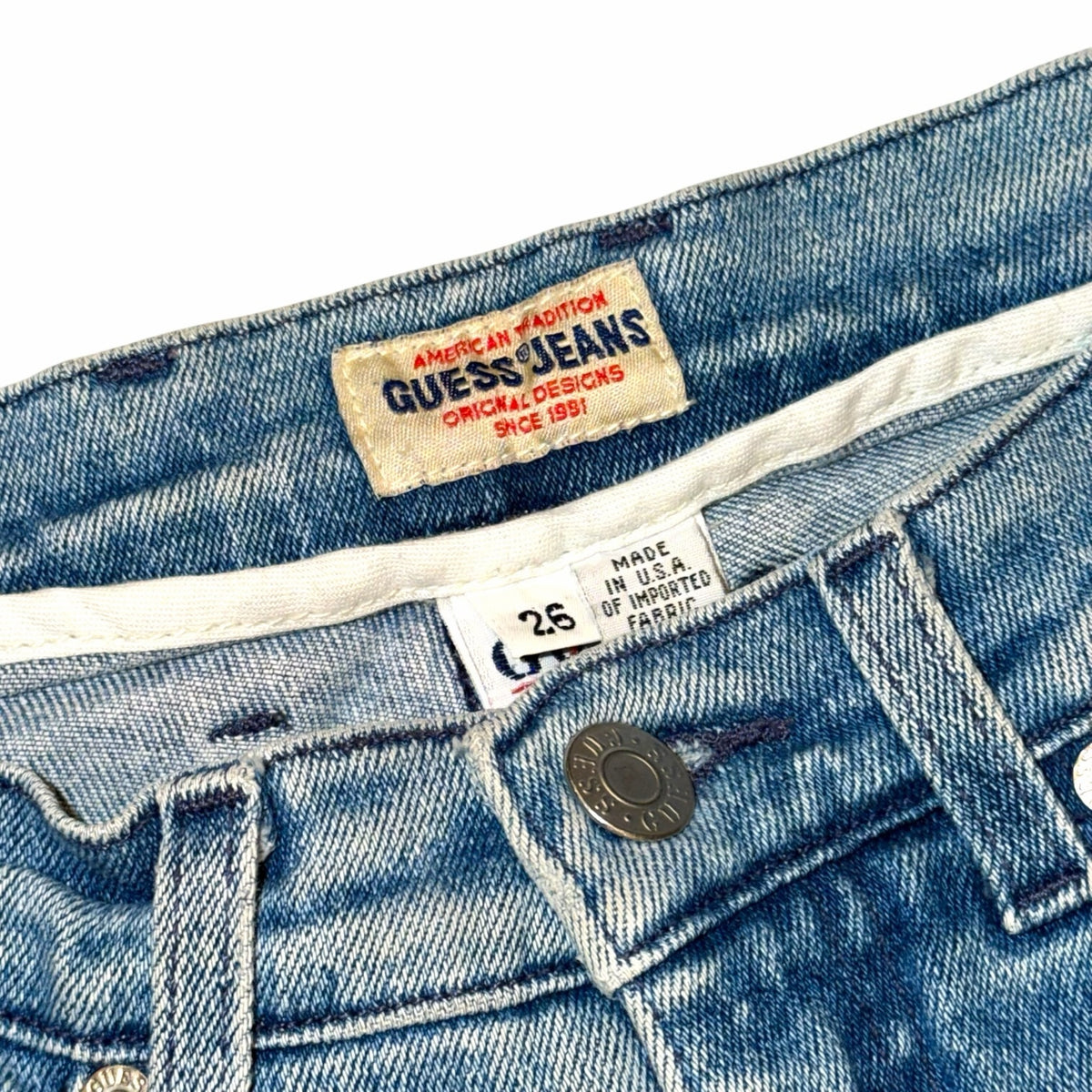 Vangsworld, Inc vintage GUESS JEANS denim pants featuring a size 26 label and classic medium-blue wash fabric.