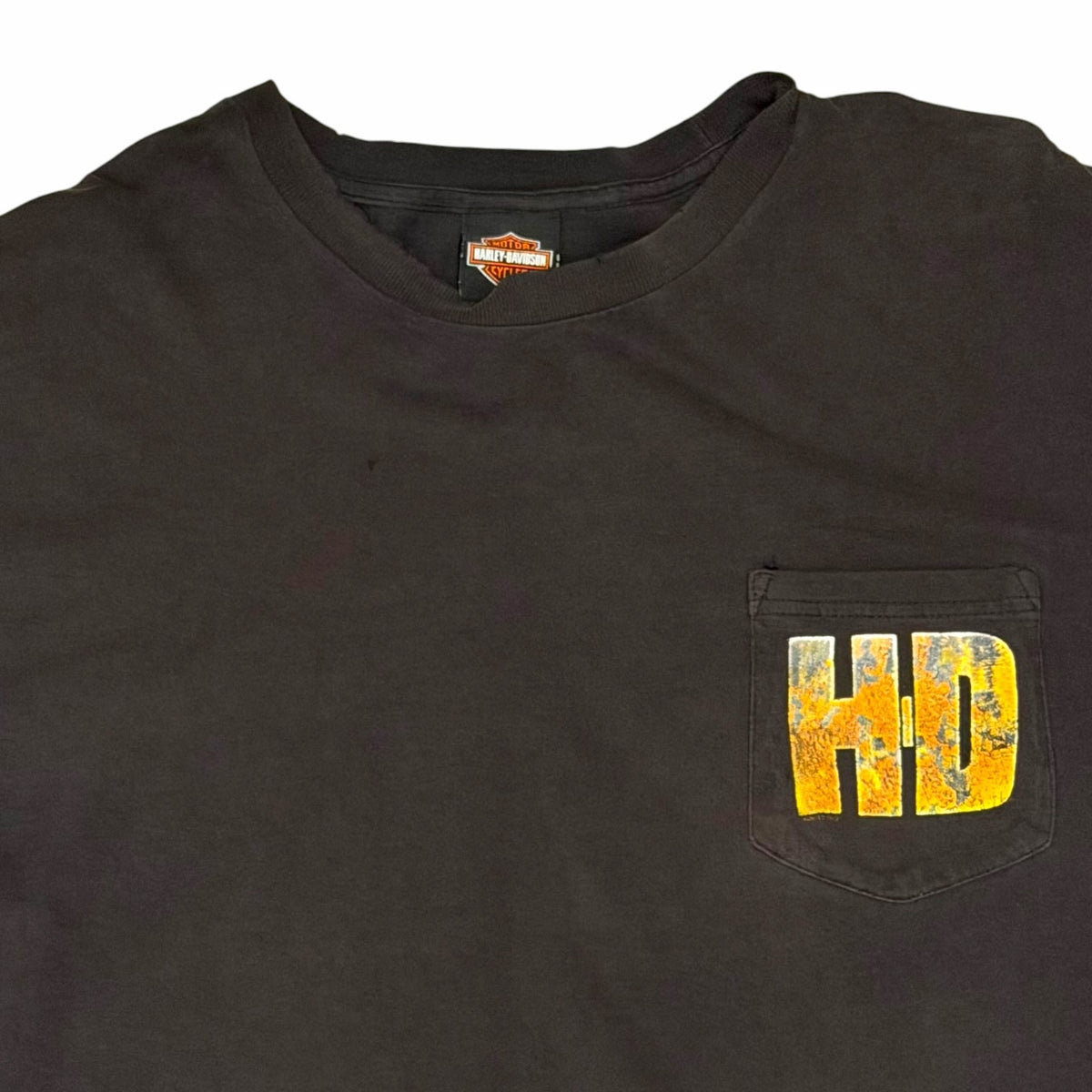 Vangsworld, Inc black Harley-Davidson cotton t-shirt featuring a chest pocket with a distressed yellow HD graphic