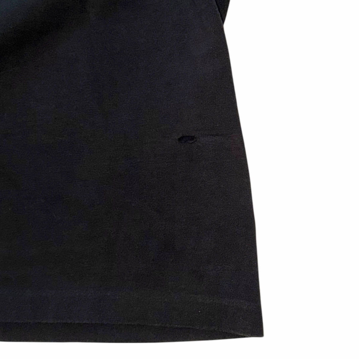 Vangsworld, Inc black cotton Harley-Davidson tank top showing a small, subtle hole on the lower front fabric