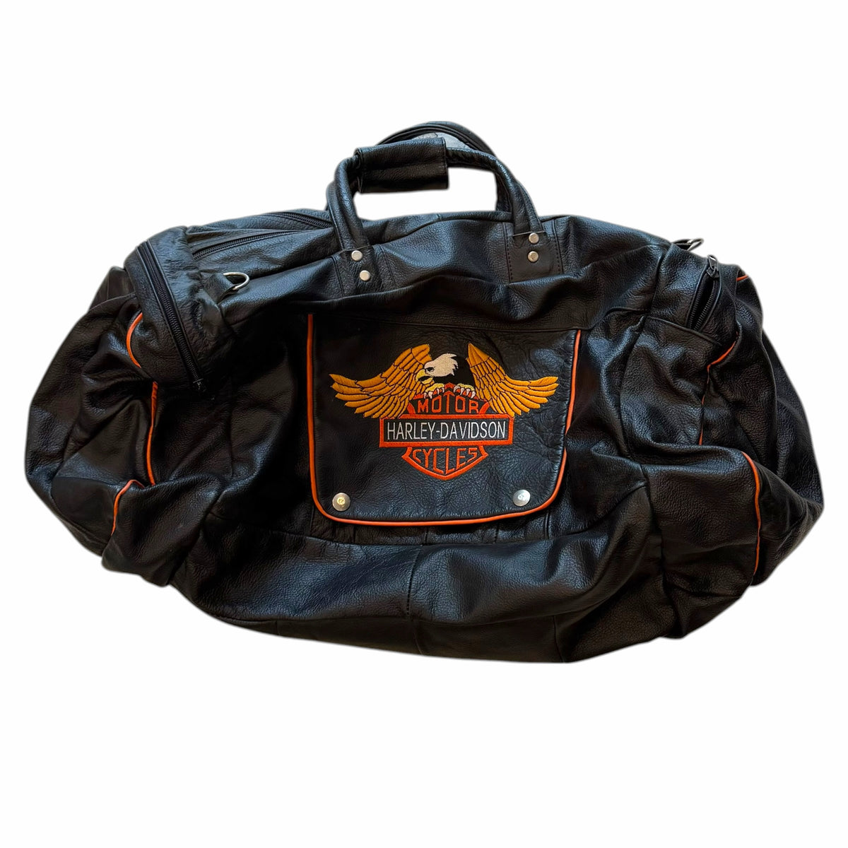 Vangsworld, Inc Harley-Davidson black leather duffel bag with orange piping and eagle logo patch on front pocket