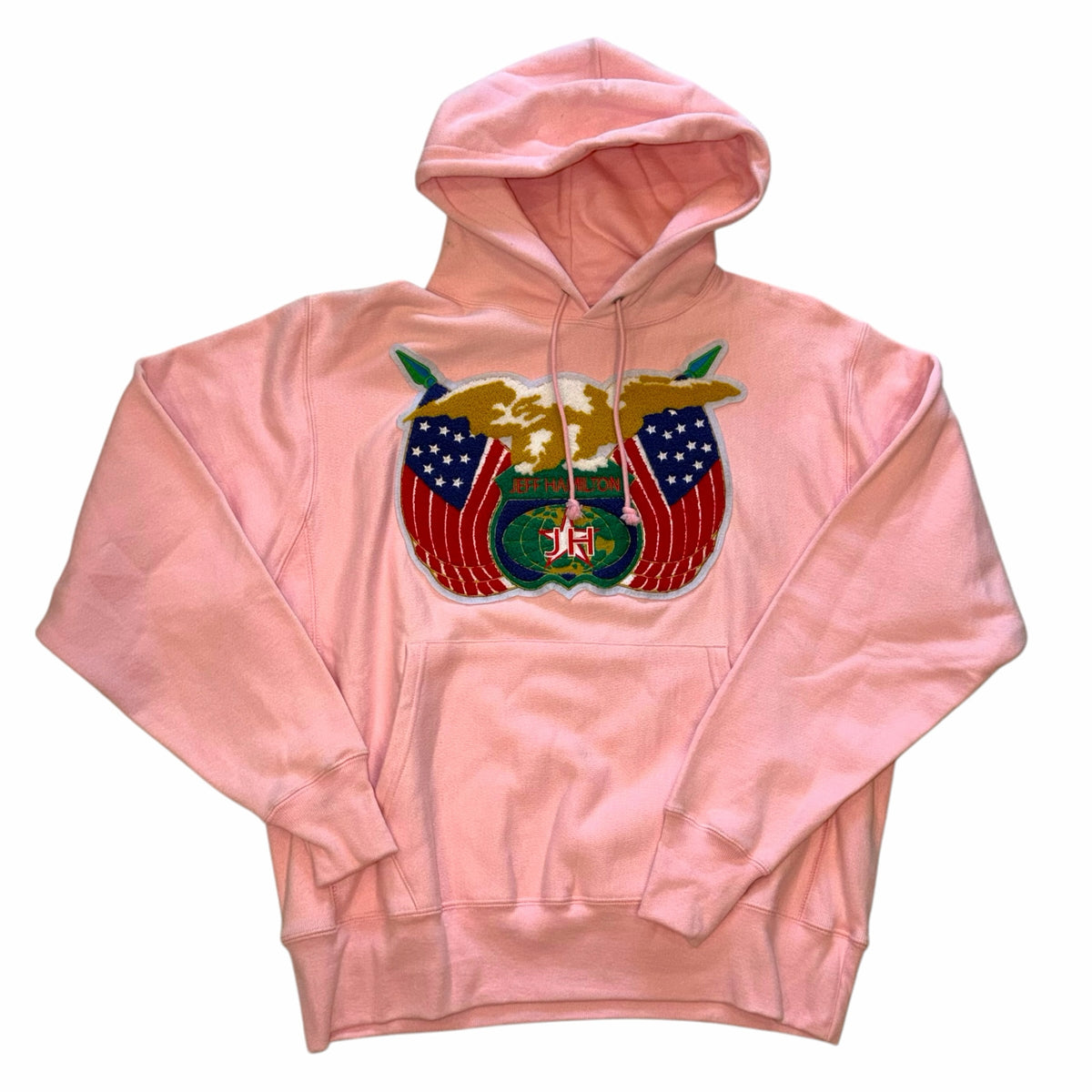 Vangsworld, Inc Jeff Hamilton pastel pink pullover hoodie with large embroidered eagle and American flag chest patch.