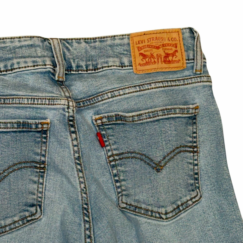 Vangsworld, Inc light-wash blue denim jeans featuring a signature Levi's leather back patch and iconic red tab detail.