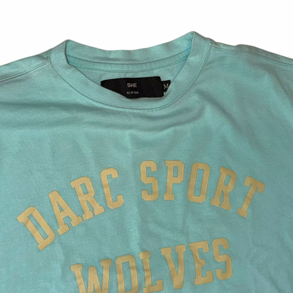 Vangsworld, Inc mint green Darc Sport Wolves graphic crop top with a crew neckline and vintage-style lettering.