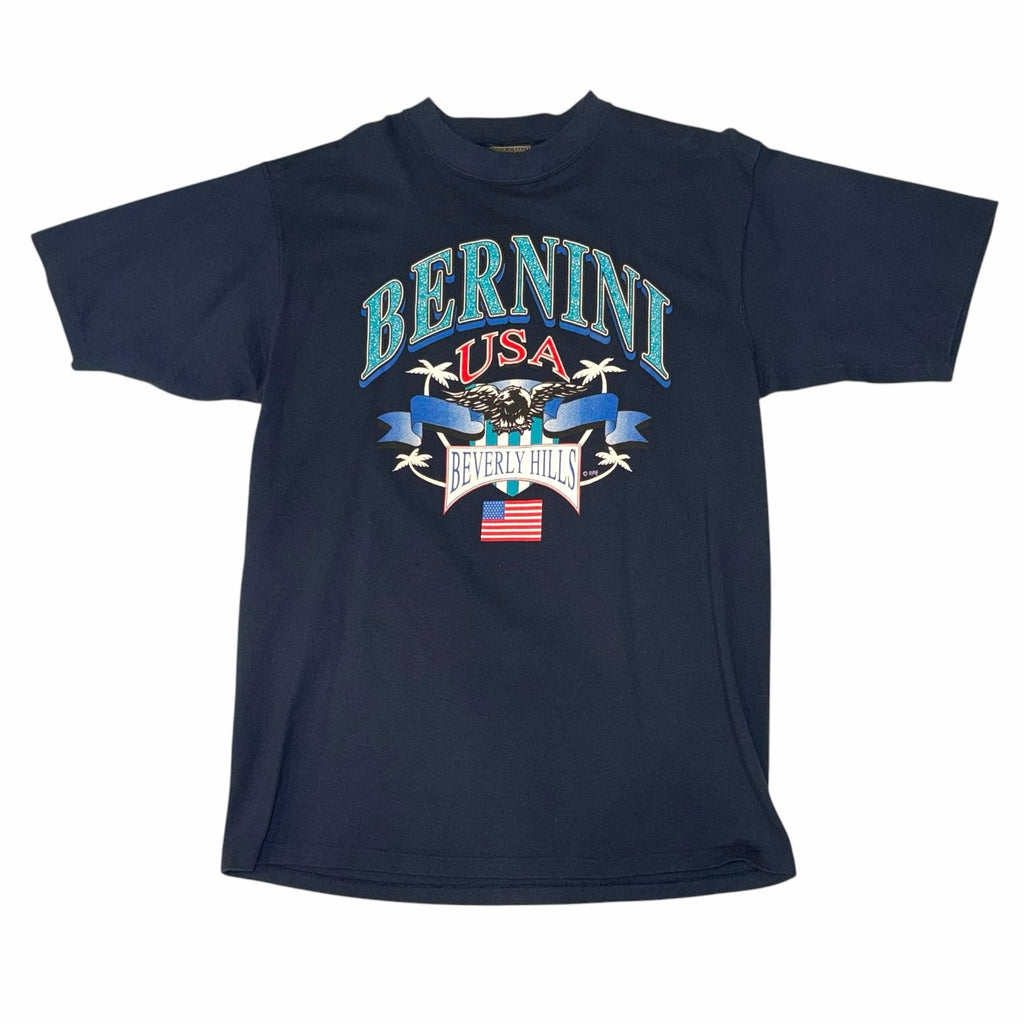 Vangsworld, Inc navy blue cotton crewneck t-shirt featuring a vintage Bernini USA Beverly Hills eagle graphic print.