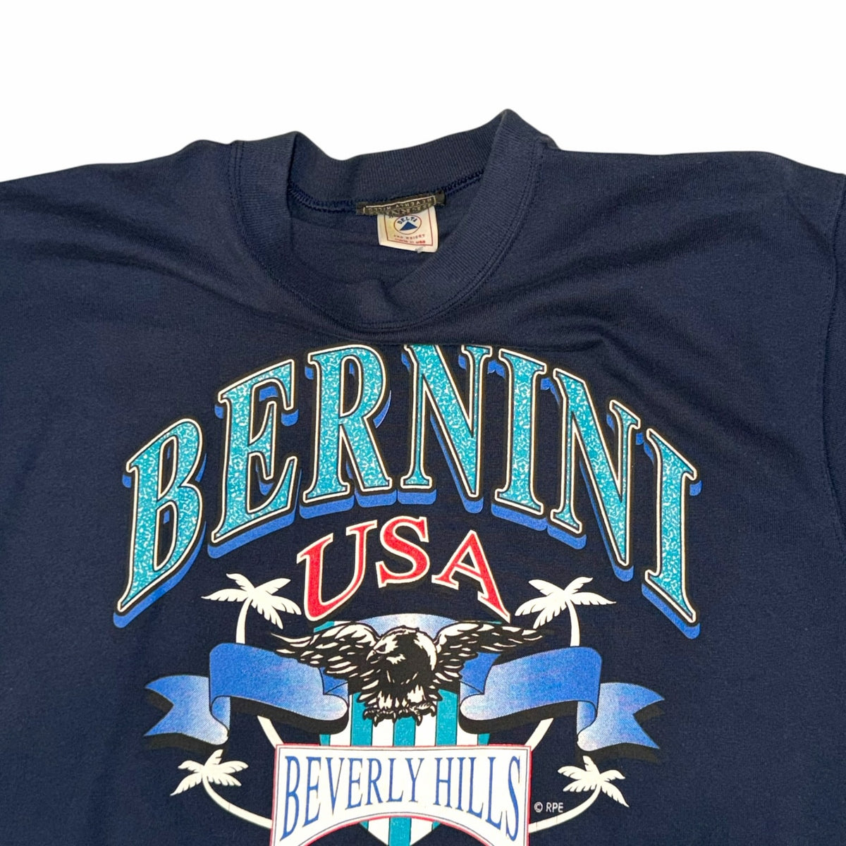 Vangsworld, Inc navy blue crewneck t-shirt featuring a vintage Bernini USA Beverly Hills eagle and palm tree graphic