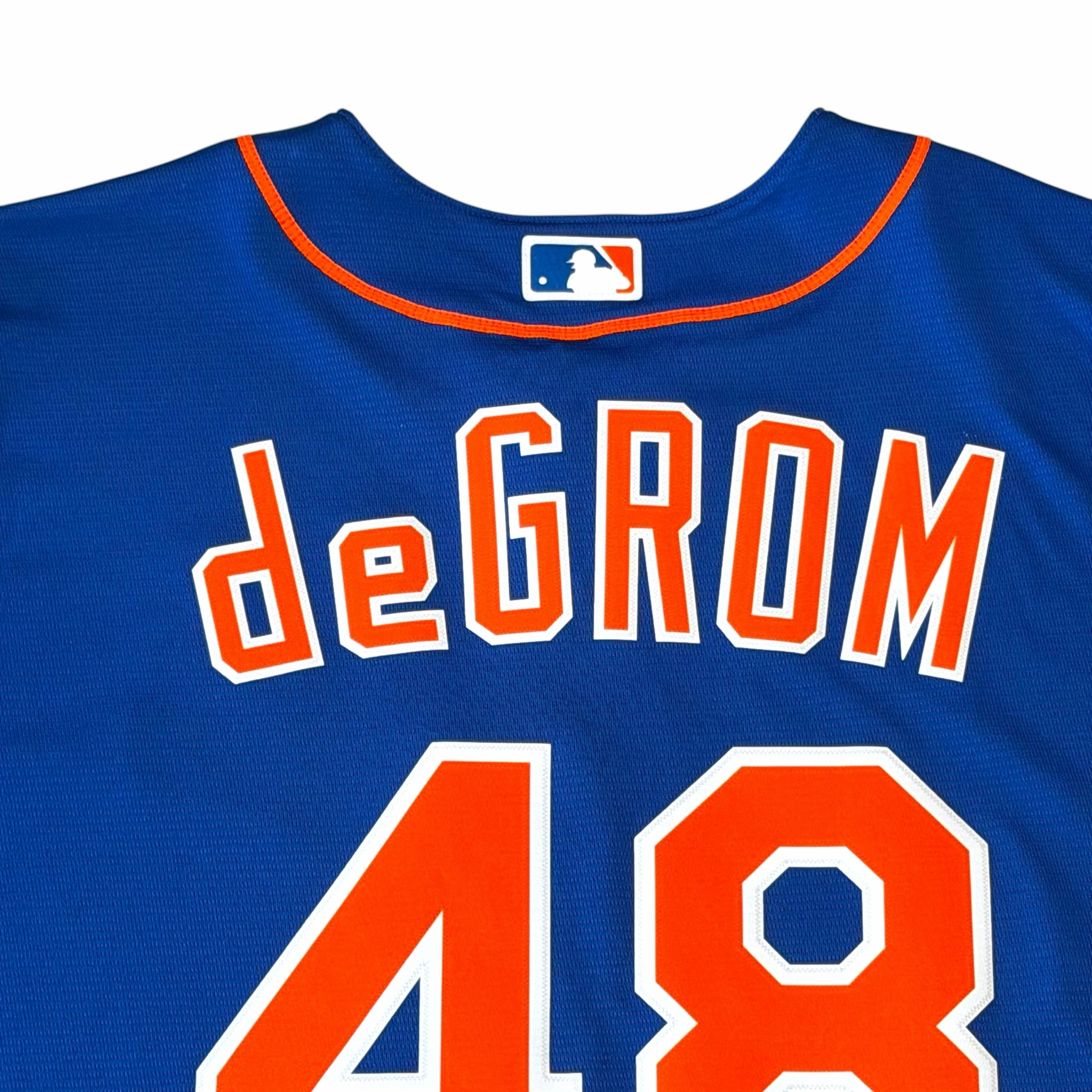 Vangsworld, Inc New York Mets Jacob deGrom jersey in royal blue with orange lettering and MLB logo on the back neck.
