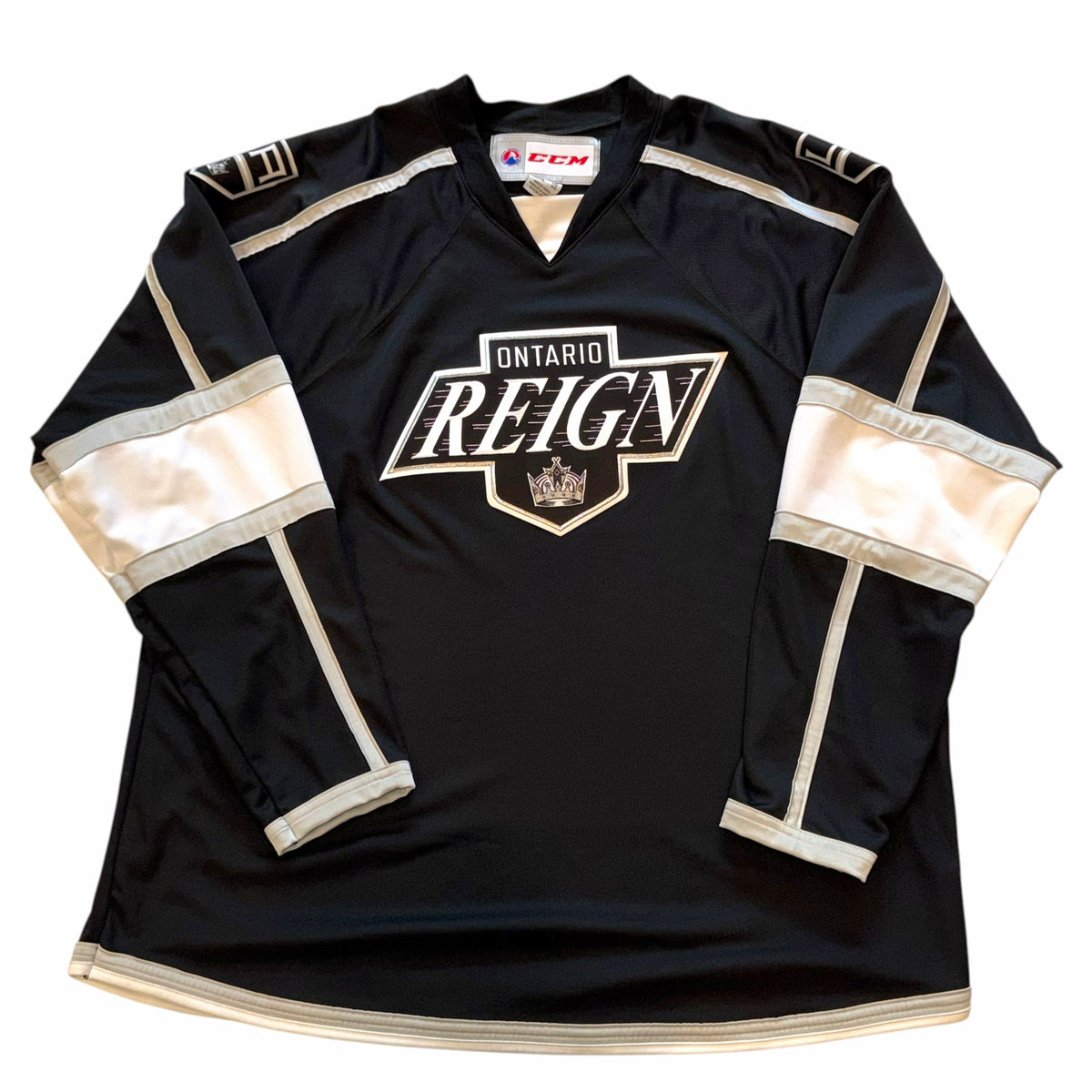 Vangsworld, Inc Ontario Reign professional hockey jersey in black, white, and silver with team crest and CCM branding.