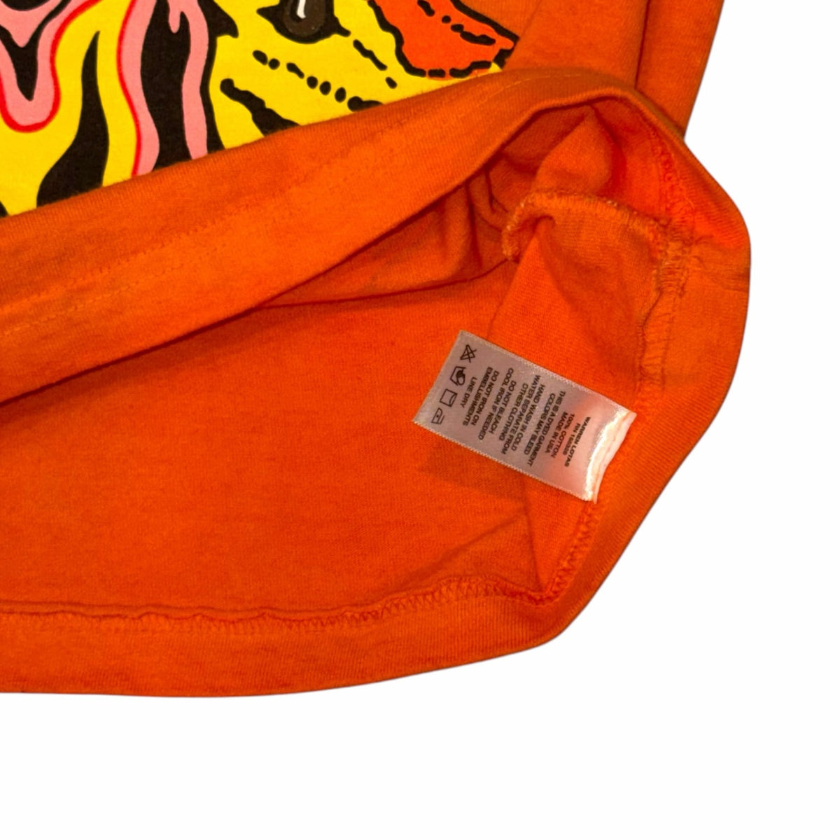Vangsworld, Inc orange cotton graphic t-shirt interior with care label and vibrant screen print detail