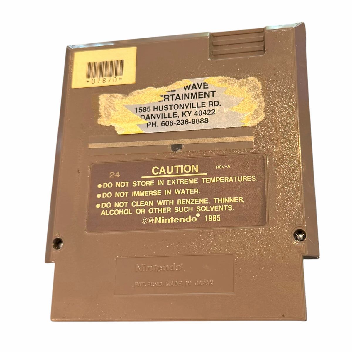 Back of Vangsworld, Inc Silent Service NES game cartridge showing caution label and rental store sticker
