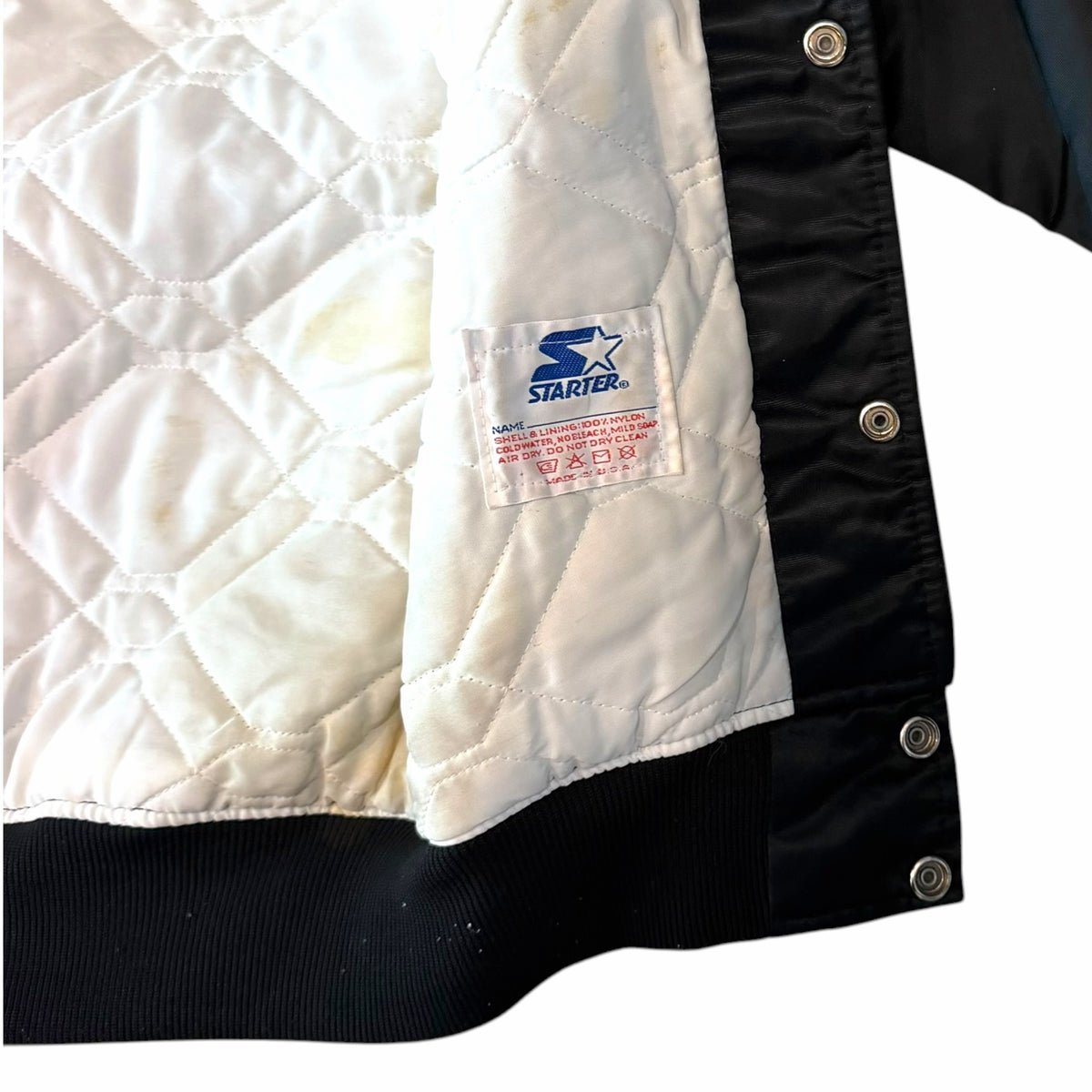 Vangsworld, Inc vintage Starter Cincinnati Bengals jacket interior showing white quilted lining and care label