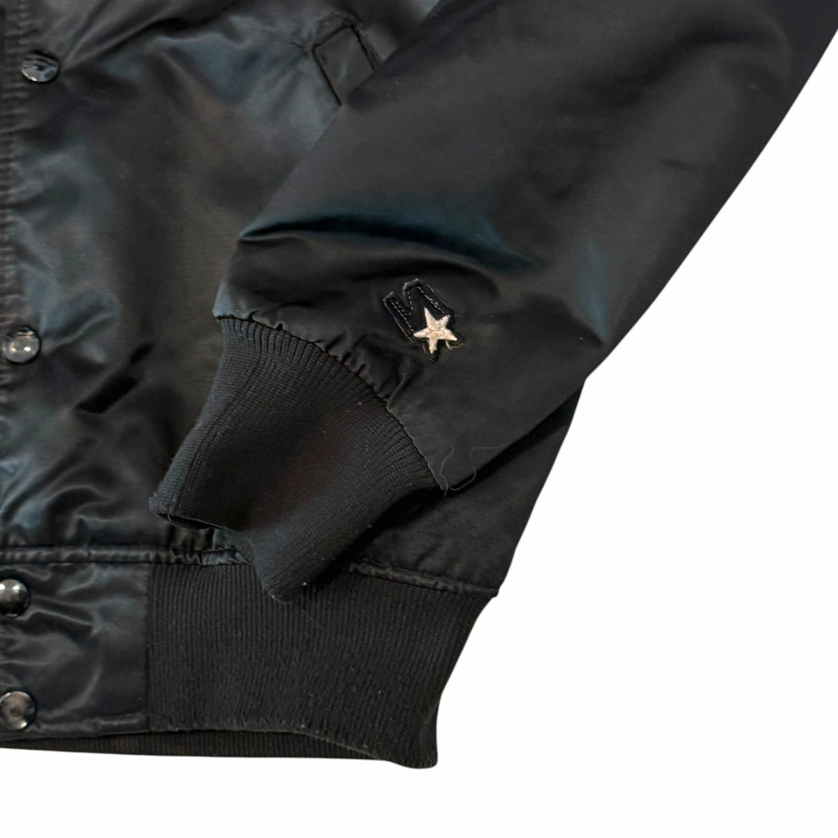 Vangsworld, Inc black satin Starter football jacket sleeve with embroidered logo and ribbed cuff detail
