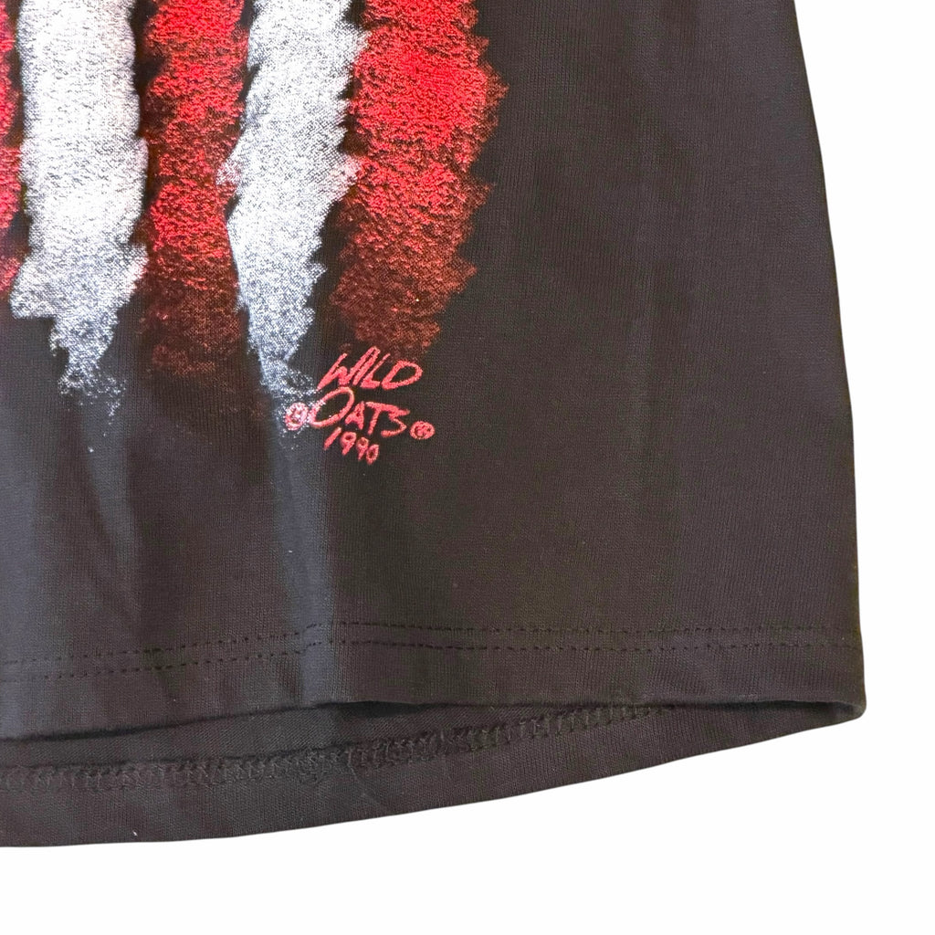 Vangsworld, Inc black cotton t-shirt featuring a distressed red and white American flag graphic with 1990 Wild Oats logo