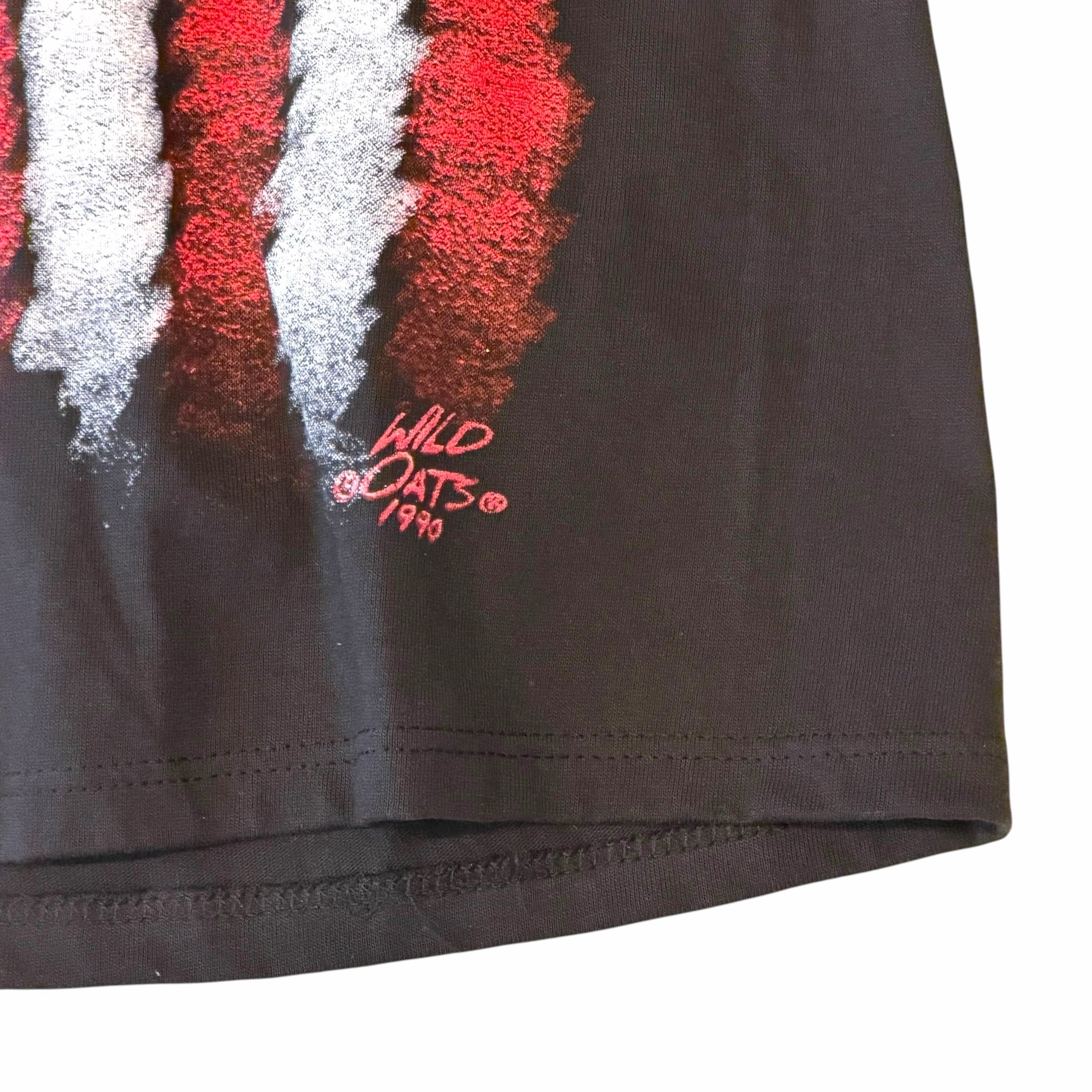 Vangsworld, Inc black cotton t-shirt featuring a distressed red and white American flag graphic with 1990 Wild Oats logo