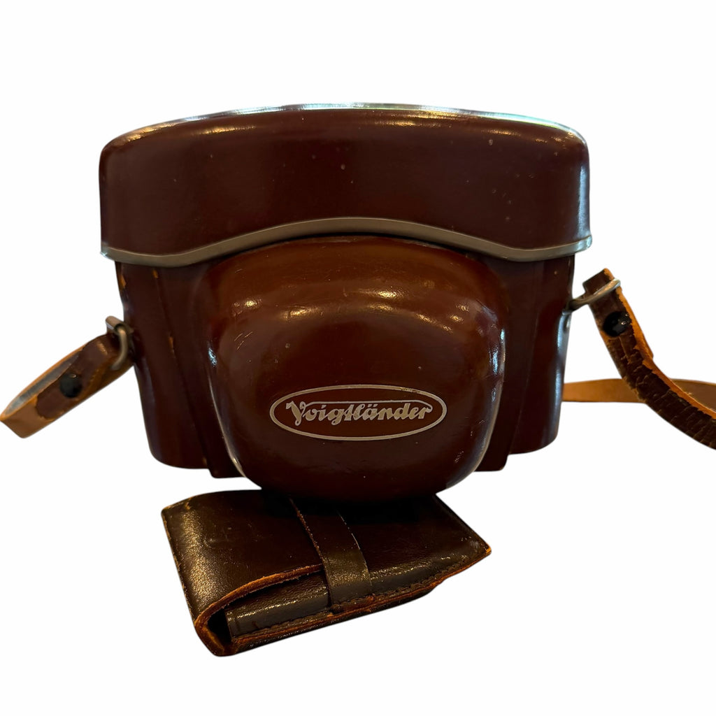 Vangsworld, Inc vintage Voigtländer rangefinder camera inside its original brown leather protective carrying case.